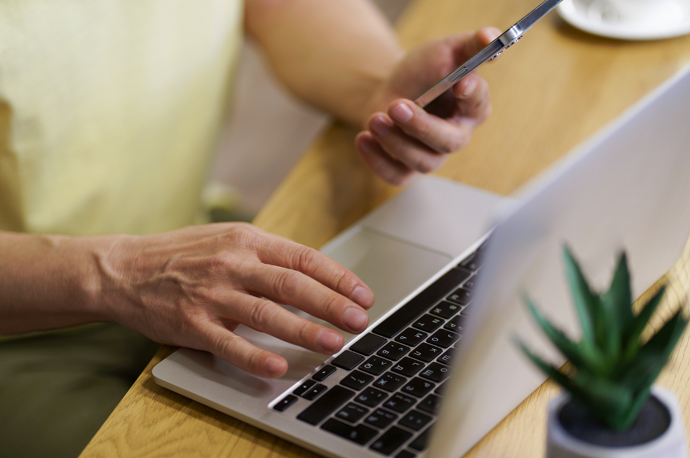 Someone researching roofing companies in Las Vegas on laptop